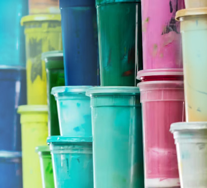 A selection of multicoloured plastic buckets stacked up.