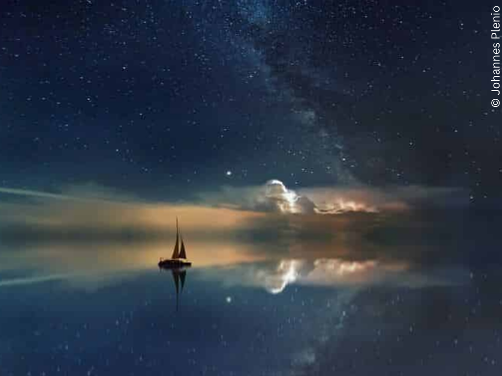 A small boat on the sea in the night stars