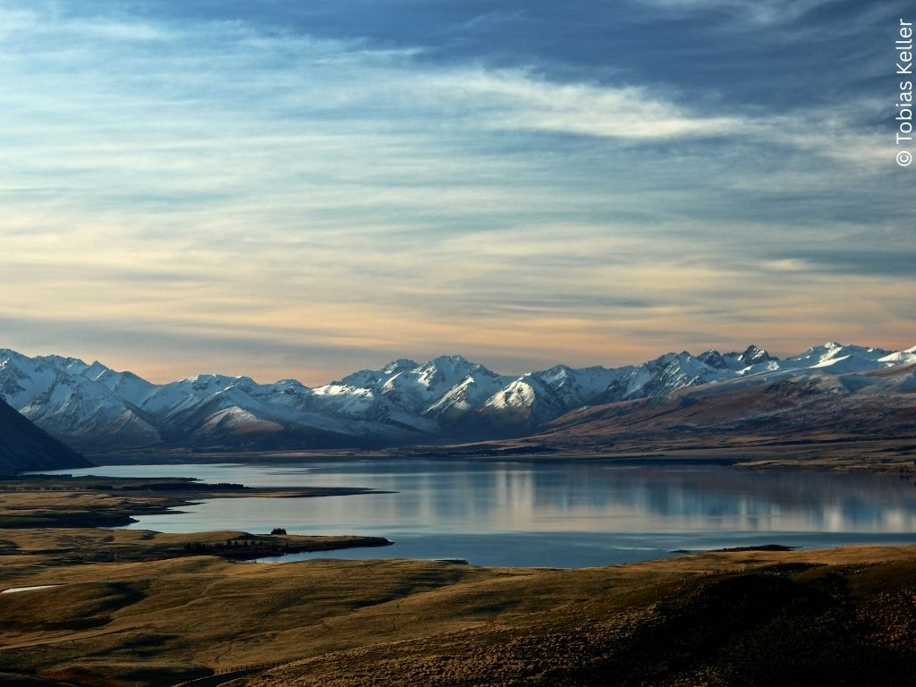 A lake with snowy mountains in the distance