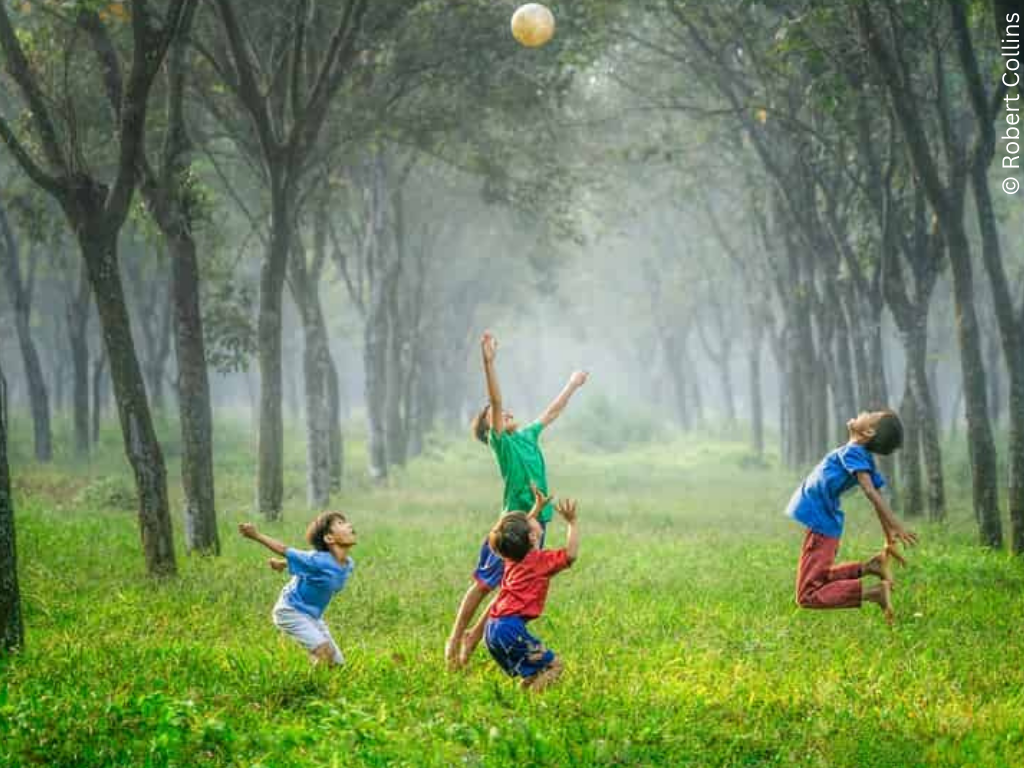 children play in a green space